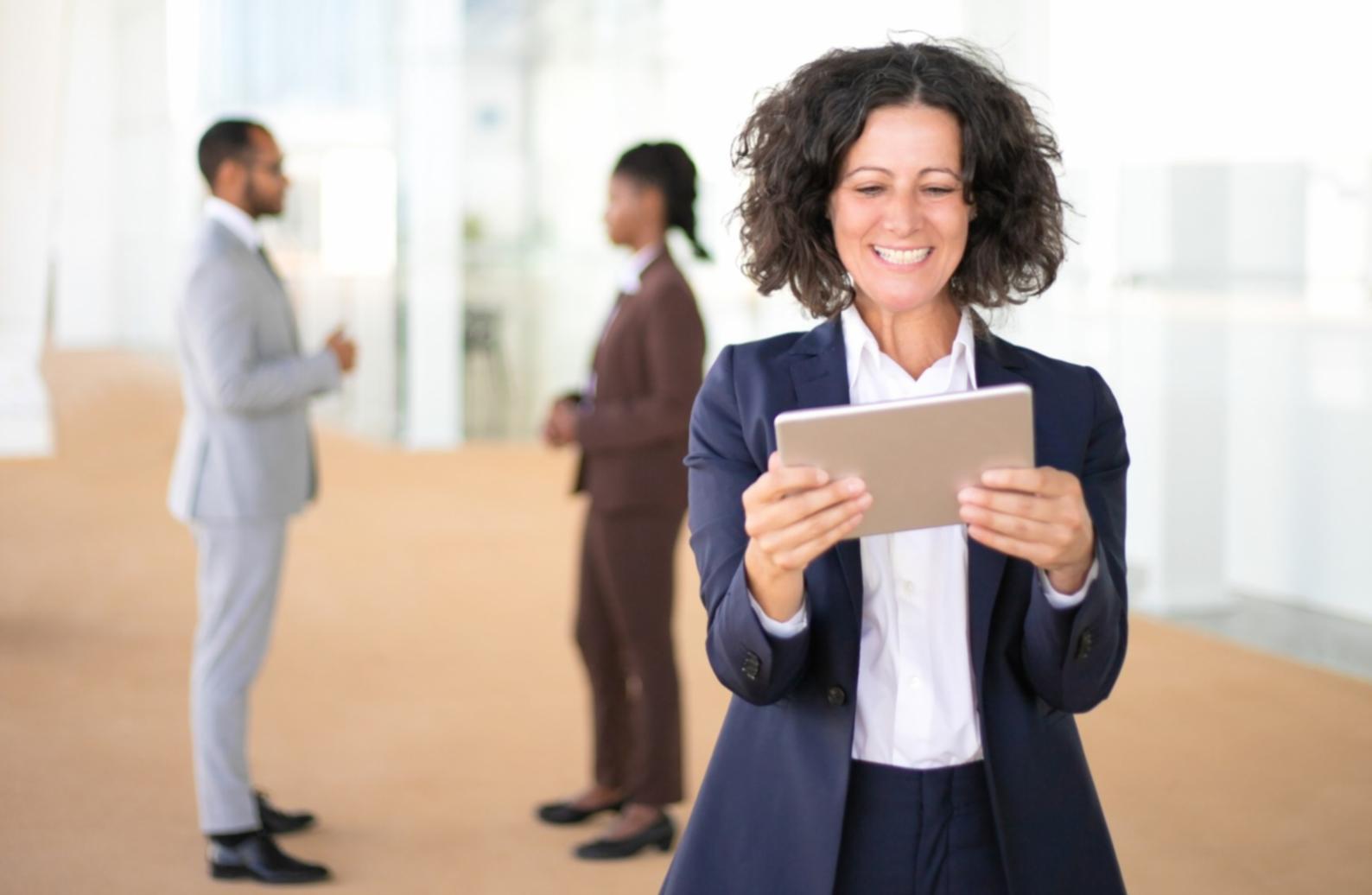 Person reviewing financial documents with calculator and notebook on desk
